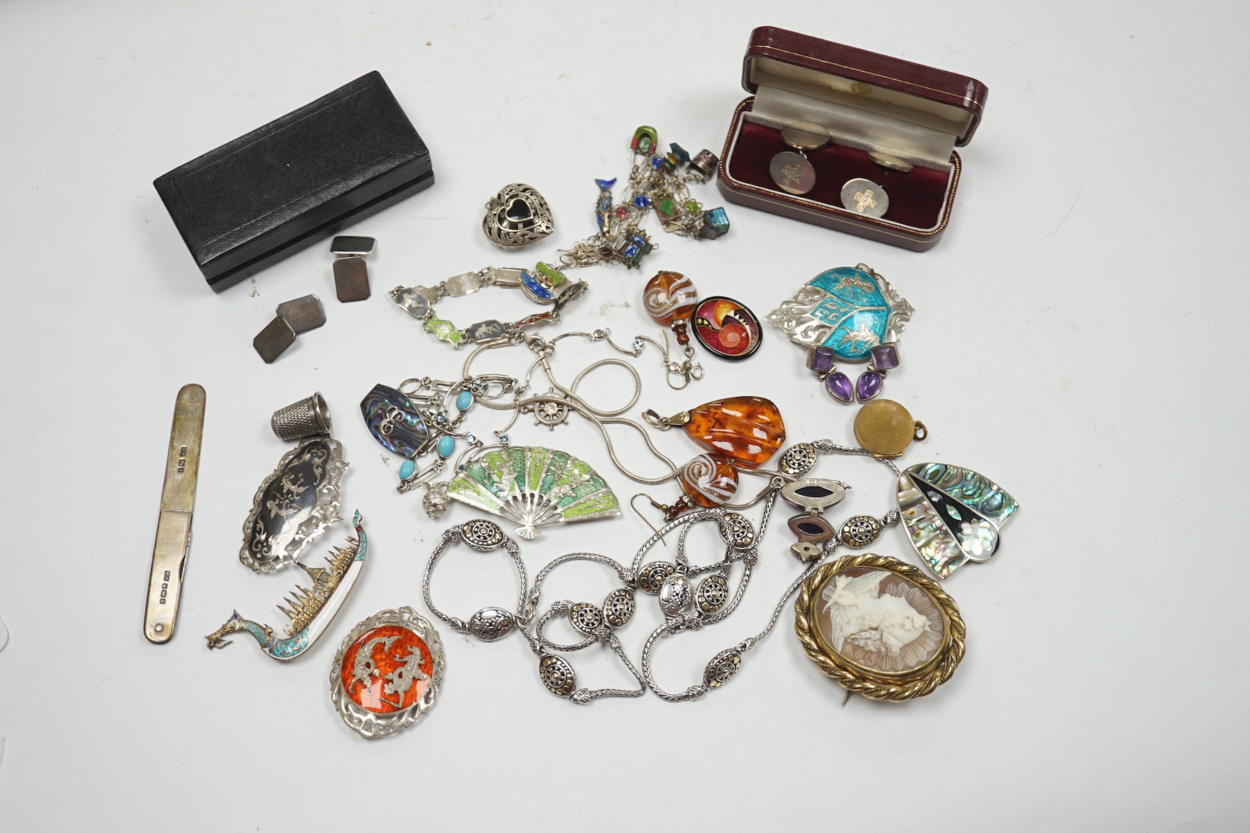 Assorted sterling , white metal and enamel jewellery including a charm bracelet, Siamese brooches, 925 and yellow metal necklace, etc. Condition - poor to fair to good